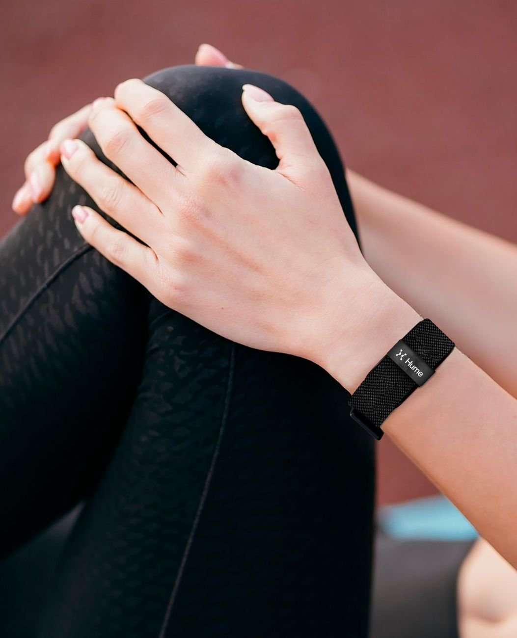 Close-up of hands and wrist wearing the Hume Band during a stretching session